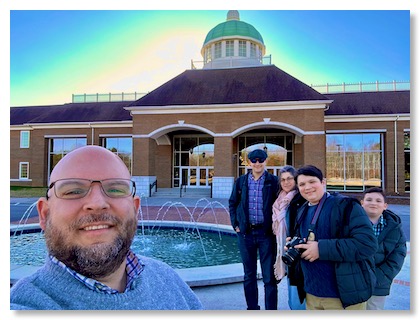family standing at the entrance of Crown College in Powell, TN